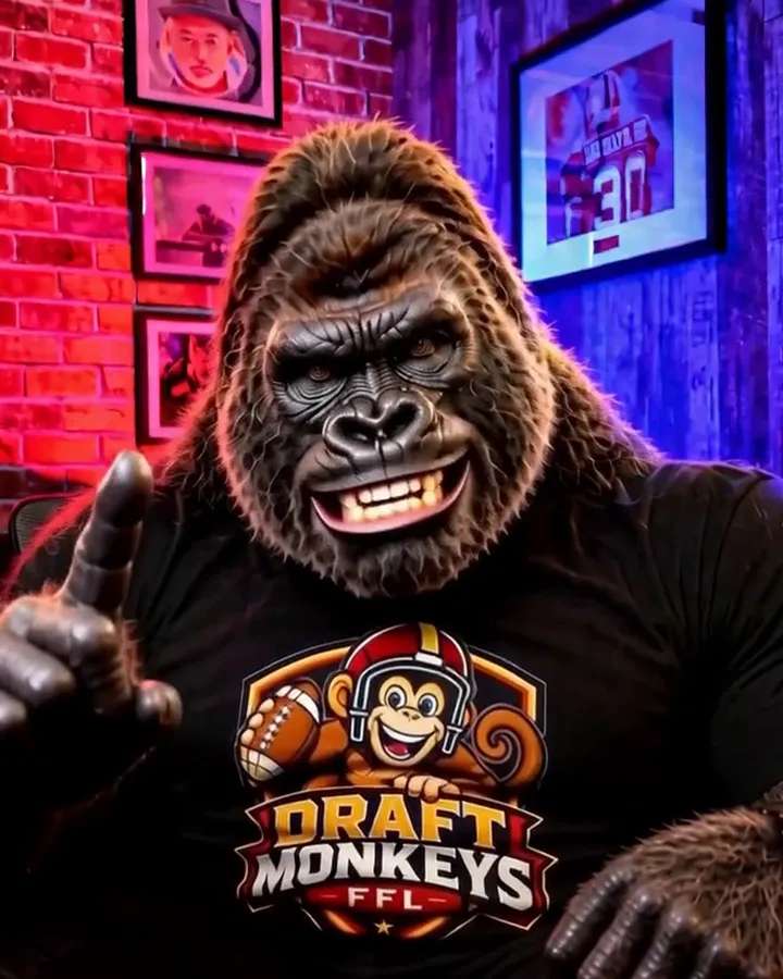Judge MK, a gorilla in a Draft Monkeys shirt, raising one finger